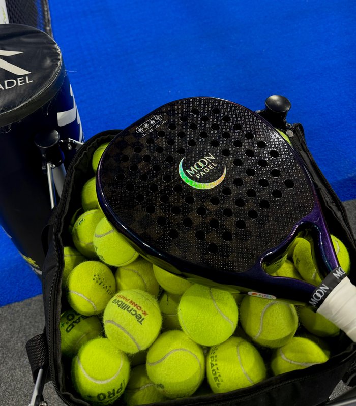 Supernova X racket resting with balls